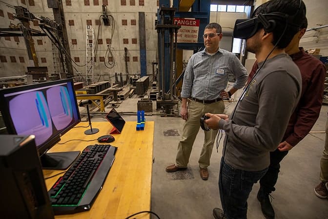 Students use virtual reality goggles to interact with surroundings