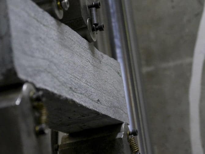 A machine applies pressure to a slab of concrete