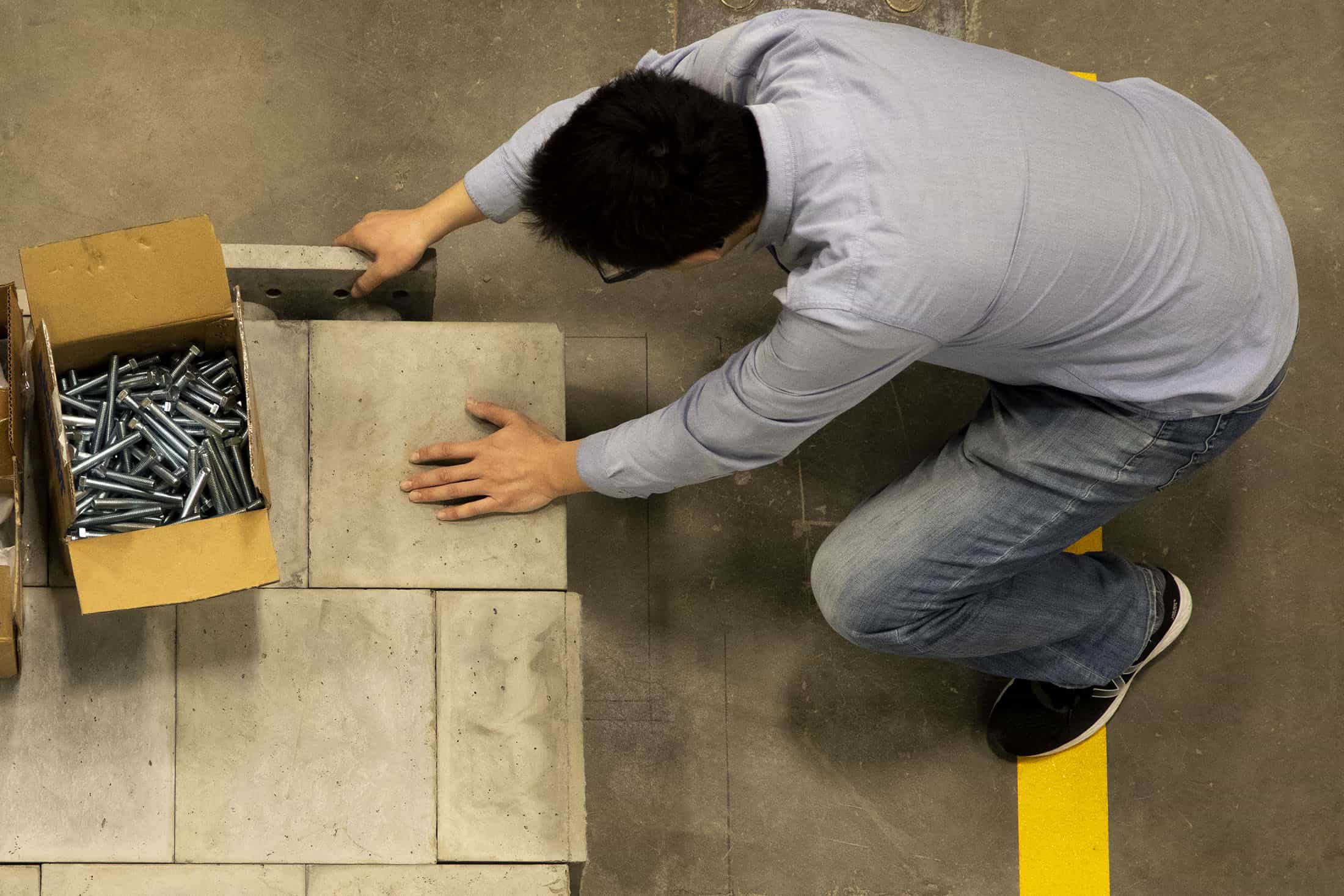 Person assembles concrete blocks