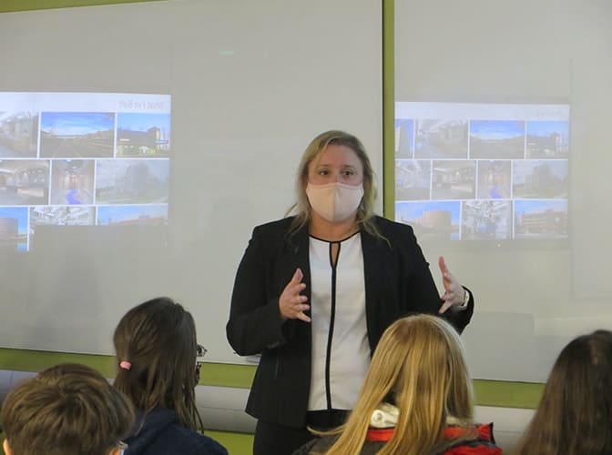 Person wearing a mask gives a presentation